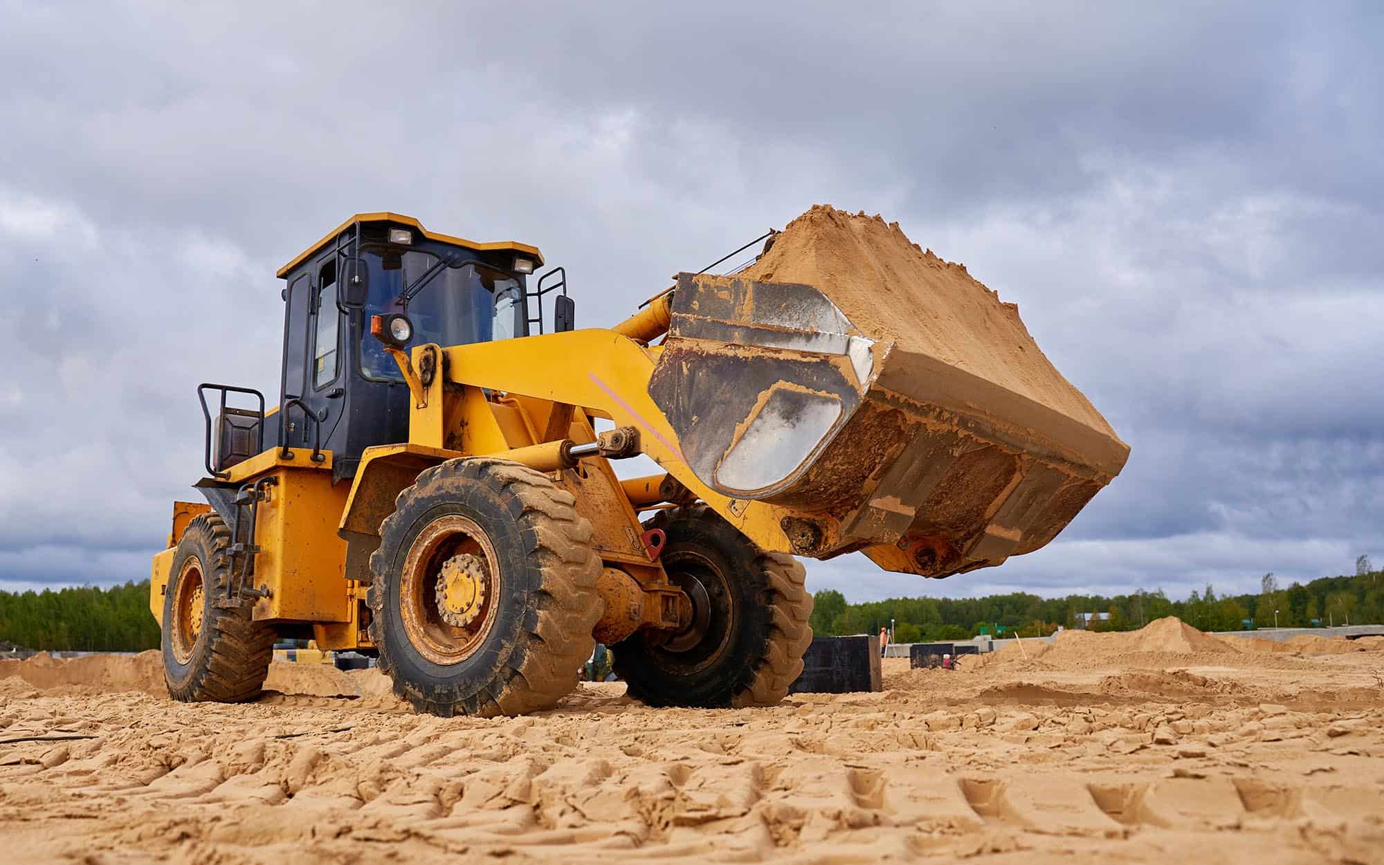 Front loader with bucket of sand