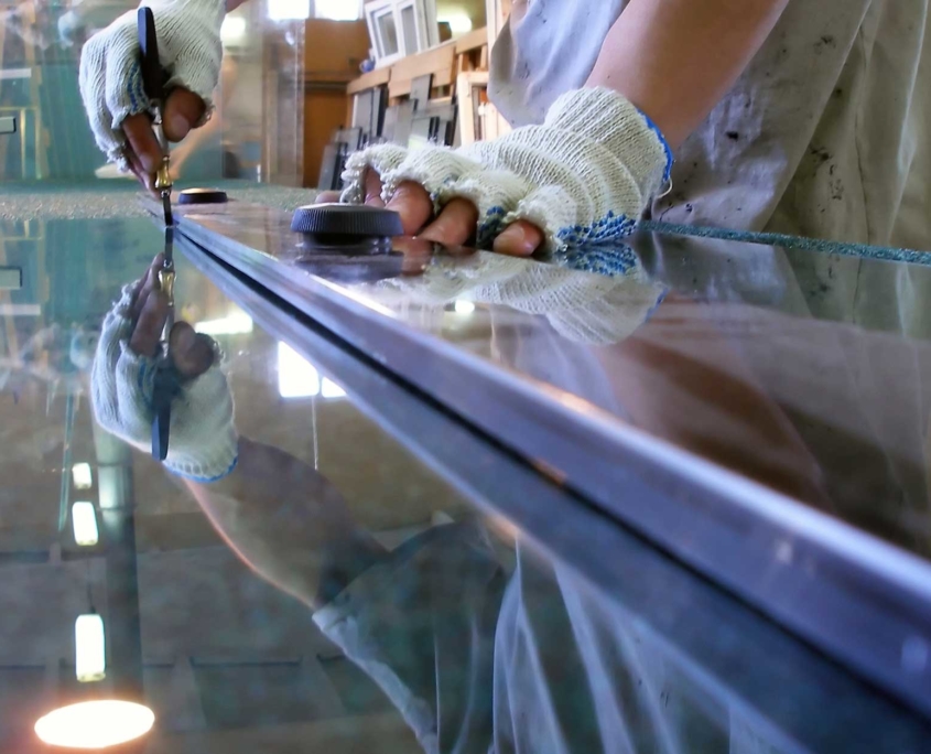 Professional glass cutter making window panes