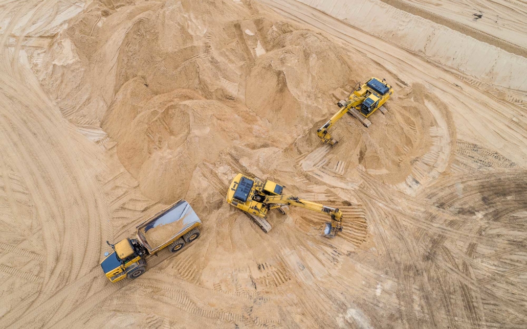 Overhead view of construction vehicles piling frac sand