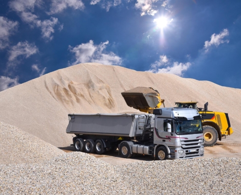 Image of a truck loading up with sand.